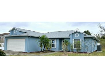 Charming one-story home with a two car garage, well-maintained lawn, and stylish architectural details at 11500 Brandiwine Ct, Clermont, FL 34711