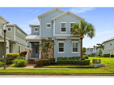 Charming two-story home with light blue siding, stone accents, and a well-manicured lawn at 1511 Fairview Cir, Kissimmee, FL 34747