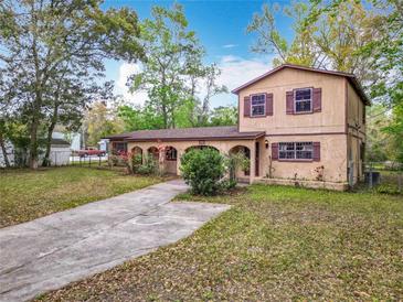Charming two-story home with arched front entryway and concrete driveway at 15523 Old Cheney Hwy, Orlando, FL 32828