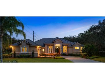 Beautiful single-story home featuring manicured landscaping, a tile roof, and a welcoming stone-accented facade at 1726 Brackenhurst Pl, Lake Mary, FL 32746