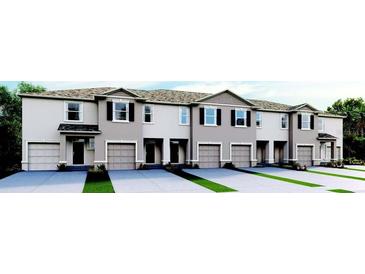 New townhomes featuring attached garages and modern architectural details at 2124 Monteverde, Davenport, FL 33896