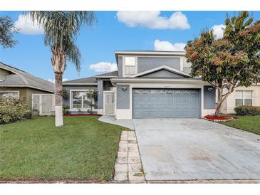 Charming two-story home with a well-manicured lawn and a two-car garage at 2570 Chatham Cir, Kissimmee, FL 34746