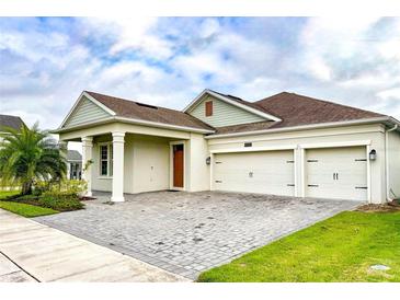 Charming single-Gathering home with a well-manicured lawn and a three-car garage at 4550 Tribute Trl, Kissimmee, FL 34746