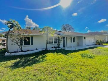 Charming single-story home with a well-maintained lawn and lush landscaping, bathed in sunlight at 4706 Kimball W Ct, Lakeland, FL 33813