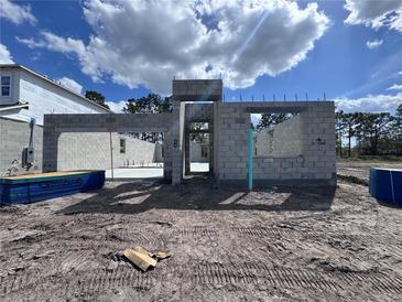 An image of the framing of a house made from concrete blocks that has begun construction on a sunny day at 5226 Prairie Preserve Run, St Cloud, FL 34772