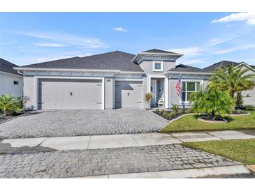 Charming single-story home with three-car garage and a well-manicured front yard at 585 Mosaic Blvd, Daytona Beach, FL 32124