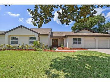 Charming single-story home with a well-manicured lawn and inviting curb appeal at 7037 Edgeworth Dr, Orlando, FL 32819