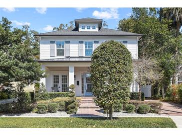 Charming two-story home with manicured landscaping and inviting front porch, enhancing curb appeal at 909 E Central Blvd, Orlando, FL 32801