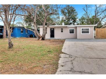 Charming single-story home with a well-maintained front yard and a concrete driveway at 913 Ferndell Rd, Orlando, FL 32808