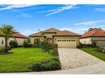 Single-story home with lush landscaping, a tile roof, and a paved driveway at 9235 San Jose Blvd, Howey In The Hills, FL 34737