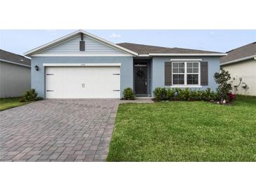 Charming single-Gathering home featuring a two-car garage, nicely landscaped yard, and brick paved driveway at 1192 Sable Glen Dr, St Cloud, FL 34771