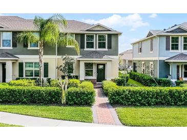 Charming townhome with manicured landscaping and a welcoming front entrance at 16027 Juniper Inlet Aly, Winter Garden, FL 34787