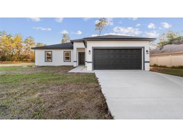 New construction home with a spacious two car garage and modern design at 16224 Sw 55Th Court Rd, Ocala, FL 34473