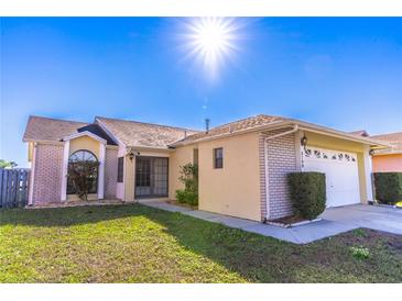 Charming single Gathering home with an attached two car garage and well manicured lawn at 3109 Bear Path, Kissimmee, FL 34746