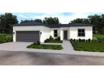 Modern single-story home with a two-car garage, gray trim and coordinated landscaping at 411 St Johns Ln, Kissimmee, FL 34759