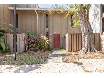 Inviting home exterior with a quaint front walkway and lush flowering bushes at 4828 Pebble Beach Dr # A, Orlando, FL 32811