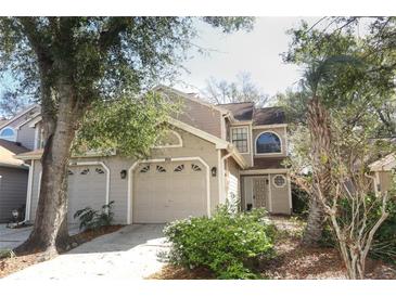 Charming home featuring a multi-car garage and a beautifully landscaped front yard with mature trees at 559 Northbridge Dr, Altamonte Springs, FL 32714