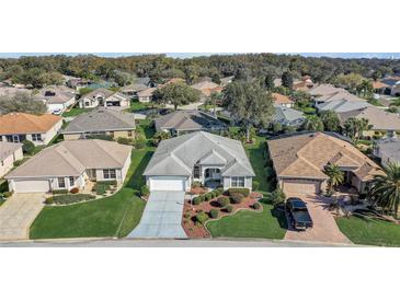 Charming single-story home with well-manicured landscaping and an attached two-car garage at 7233 Se 171St Pond Ln, The Villages, FL 32162