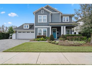 Charming two-story home with blue siding, a manicured lawn, and a welcoming front porch at 1324 Utah Blvd, Orlando, FL 32803