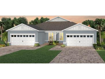 Charming single-story home featuring a two-car garage and beautiful landscaping at 13545 Pearl Beach St, Winter Garden, FL 34787