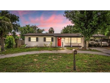 Charming single story home with a well maintained lawn, walkway, and bright red front door under a covered porch at 1412 Lakecrest Dr, Apopka, FL 32703