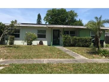 Charming single-story home with a well-maintained front yard and mature trees at 1606 Furey Dr, Orlando, FL 32822