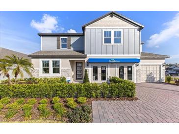 Charming two-story home featuring stone accents, landscaped yard, and a welcoming front entrance at 3235 Legends Preserve Dr, Daytona Beach, FL 32124