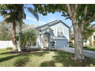 Charming two-story home featuring a manicured lawn, landscaping, and inviting curb appeal at 324 Lusitano Way, Sanford, FL 32773