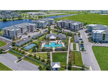 Beautiful aerial view of community amenities including pool, tennis court, and green spaces at 7545 Laureate Blvd # 7202, Orlando, FL 32827