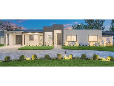 Modern home featuring manicured lawn, striking block driveway, and minimalist design at 2015 Summerfield Rd, Winter Park, FL 32792