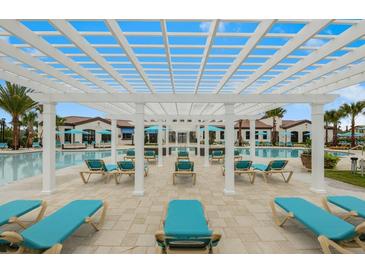 Relaxing community pool featuring lounge chairs and pergolas for shade at 2402 Dubai St, Kissimmee, FL 34747