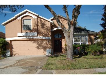 Charming two-story home with a well-maintained front lawn and inviting entryway with attractive beige and white color scheme at 4650 Redmond Pl, Sanford, FL 32771