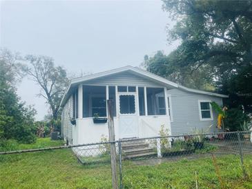 Charming home featuring a screened porch entry and a well-maintained front yard at 7531 Marietta St, Orlando, FL 32807