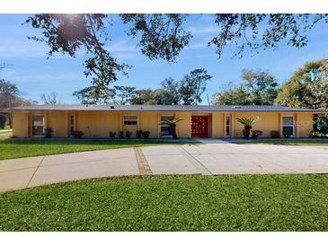 Charming single-story home features well-manicured lawn, long drive, and a stylish front entrance at 926 Ensenada Dr, Orlando, FL 32825