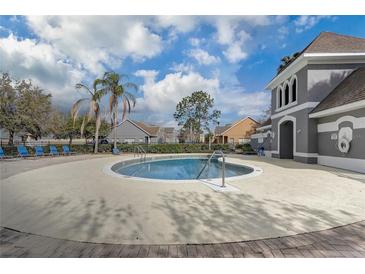 Well-maintained community pool with a clubhouse and lounge chairs for residents' enjoyment at 13046 Island Breeze Ct, Orlando, FL 32824