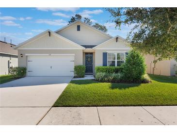 Charming single-story home with a well-maintained lawn, attached garage, and welcoming front entrance at 168 Victoria Oaks Blvd, Deland, FL 32724