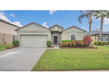 Charming single-story home with a well-maintained lawn and attached two-car garage at 2233 Tulip Valley Pt, Sanford, FL 32771