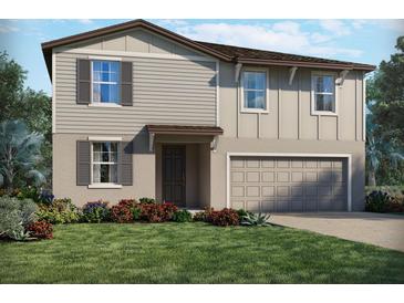 Two-story home featuring beige siding, a two-car garage, and well-maintained landscaping with colorful flowering shrubs at 2318 White Tail St, Davenport, FL 33837