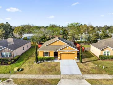 Charming single-Gathering home with a two-car garage and well-maintained landscaping at 281 Edisto Pl, Apopka, FL 32712