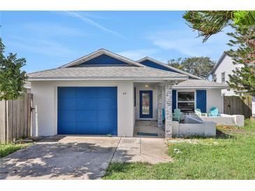 Charming home with a vibrant blue garage door and stylish brick accents at 44 Capistrano Dr, Ormond Beach, FL 32176