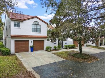 Charming townhome with a red tile roof, two-car garage, and a well-manicured front yard at 520 Via Verona Lane # 103, Altamonte Springs, FL 32714