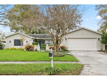 Charming single-story home with a well-maintained front yard, beautiful landscaping, and inviting curb appeal at 611 Aldama Ct, Ocoee, FL 34761