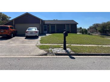 Charming single Gathering home with a well-maintained lawn and a private driveway for multiple vehicles at 6360 Powerpointe, Orlando, FL 32818