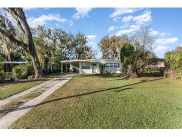 Charming single-story home features a welcoming front lawn and covered parking at 1140 W Seminole Trl, Bartow, FL 33830