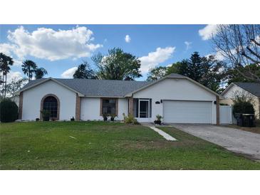 Charming single Gathering home featuring a well-maintained lawn and attached two-car garage at 272 Loma Bonita Dr, Davenport, FL 33837
