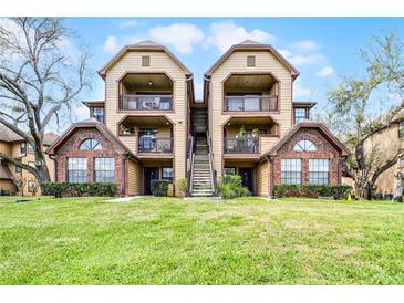 Inviting two-story condo building featuring charming balconies and lush green lawn in a well-maintained community at 305 Lakepointe Dr # 103, Altamonte Springs, FL 32701