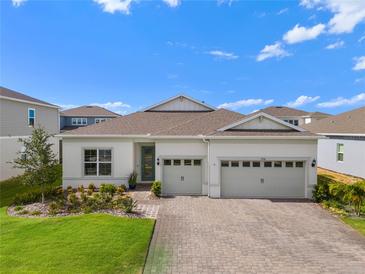 Charming home with a well-manicured lawn, beautiful landscaping, and a three car garage at 3186 Sailing Pier Ave, Winter Garden, FL 34787