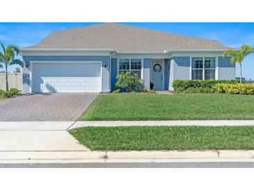 Charming single-Gathering home showcasing a manicured lawn and attached two-car garage at 4210 Sunset Preserve Blvd, Orlando, FL 32820