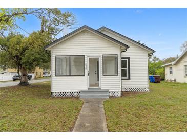 Charming single-story home with white siding, black trim, and a well-maintained lawn at 624 Illinois Ave, St Cloud, FL 34769