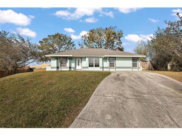 Charming single-story home featuring a well-maintained lawn and extended driveway at 12419 Eryn Ct, Clermont, FL 34711